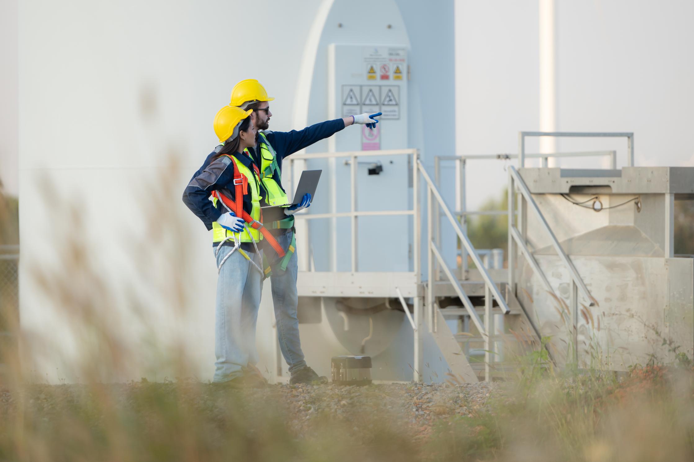 Engineers discussing the progress of a wind farm project in Queensland